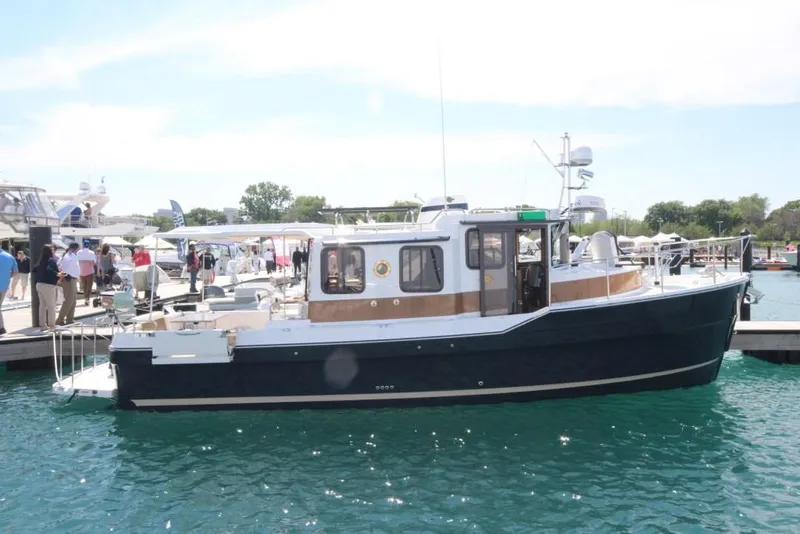 Slide: The Image of 2024 Ranger Tugs R-31 Sedan Luxury Edition docked at marina. - 35