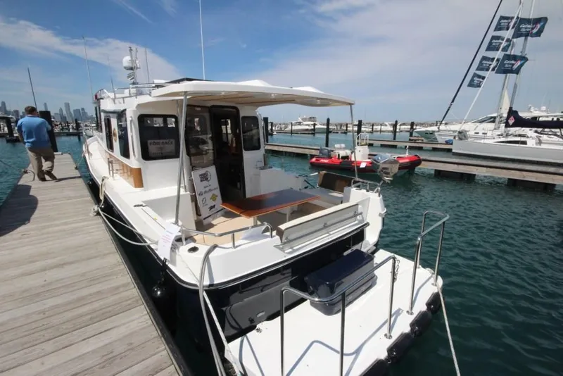 Slide: The Image of 2024 Ranger Tugs R-31 Sedan Luxury Edition docked at marina. - 41