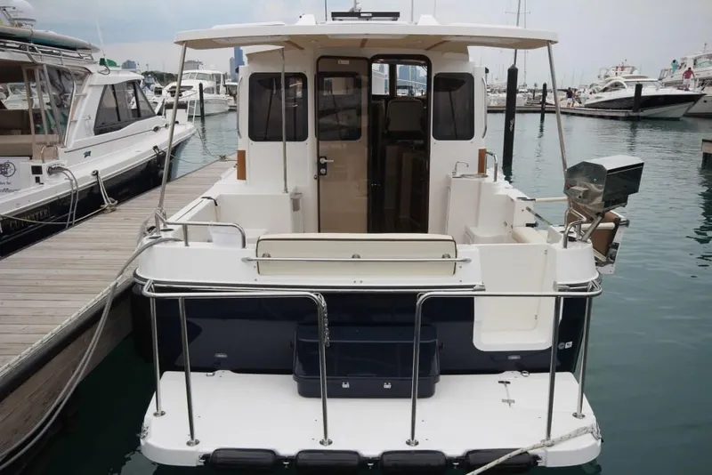 Slide: The Image of 2024 Ranger Tugs R-31 Sedan Luxury Edition docked at marina, rear view. - 42