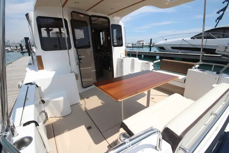 Slide: The Image of 2024 Ranger Tugs R-31 Sedan Luxury Edition boat deck with seating and table. - 48