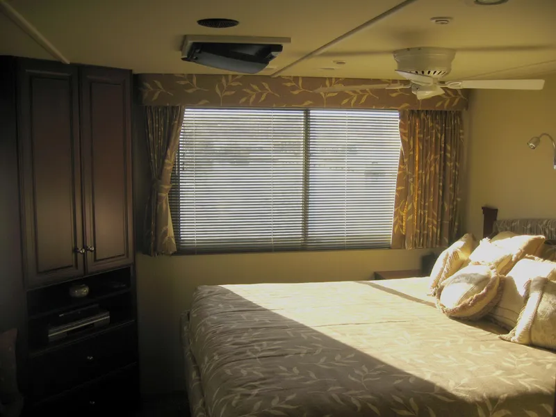 Slide: The Image of Luxurious bedroom interior of 2004 Skipperliner Dream Chaser Group C with elegant decor and natural light. - 16