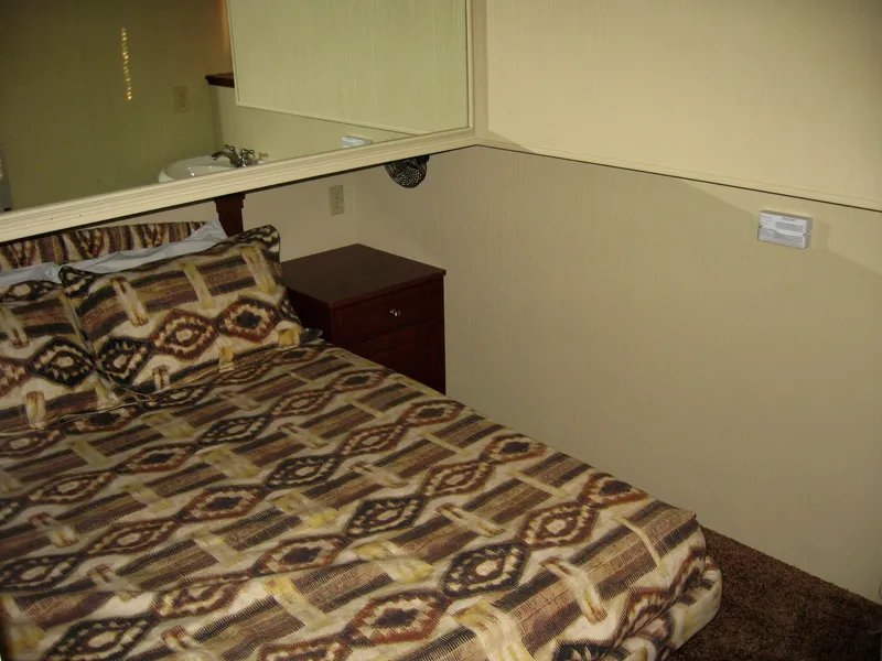 Slide: The Image of Small bedroom with patterned bedding in 2004 Skipperliner Dream Chaser Group C boat. - 17