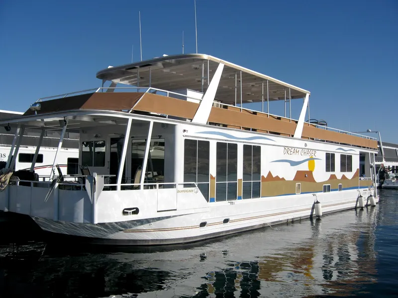 Slide: The Image of 2004 Skipperliner Dream Chaser Group C houseboat docked on calm water. - 3
