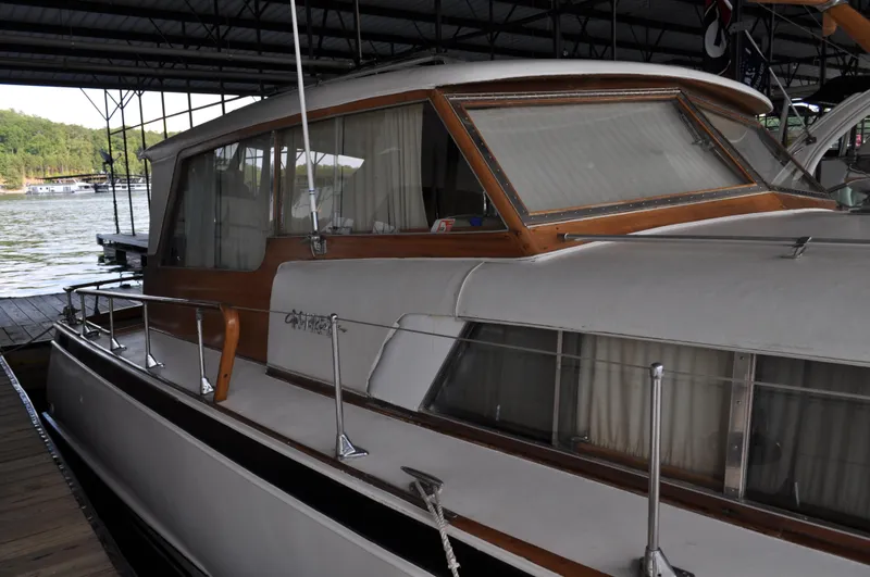Slide: The Image of 1960 Chris-Craft Roamer boat docked in a covered marina. - 11