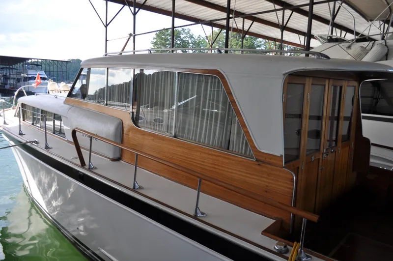 Slide: The Image of 1960 Chris-Craft Roamer boat with wooden accents docked in a covered marina. - 14