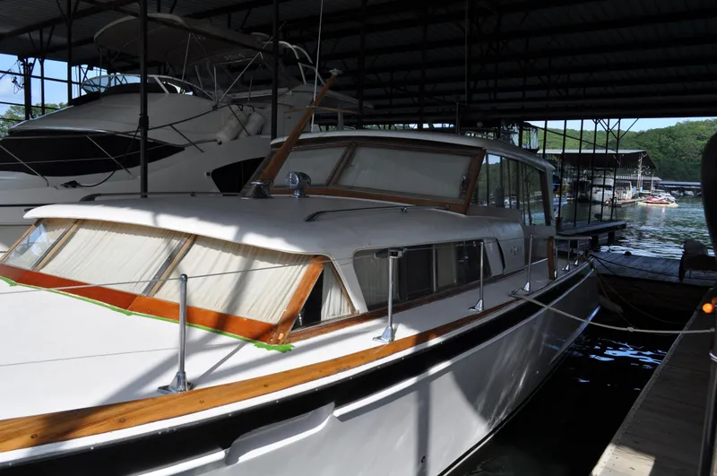 Slide: The Image of 1960 Chris-Craft Roamer docked in a covered marina. - 16