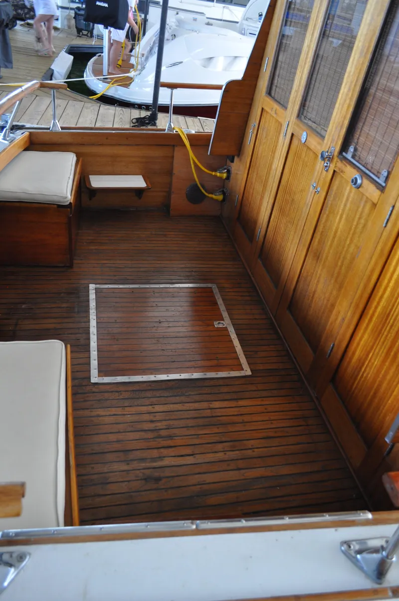Slide: The Image of 1960 Chris-Craft Roamer boat interior with wooden deck and cushioned seating. - 17