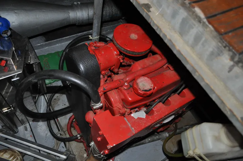 Slide: The Image of 1960 Chris-Craft Roamer engine compartment with red engine components. - 19