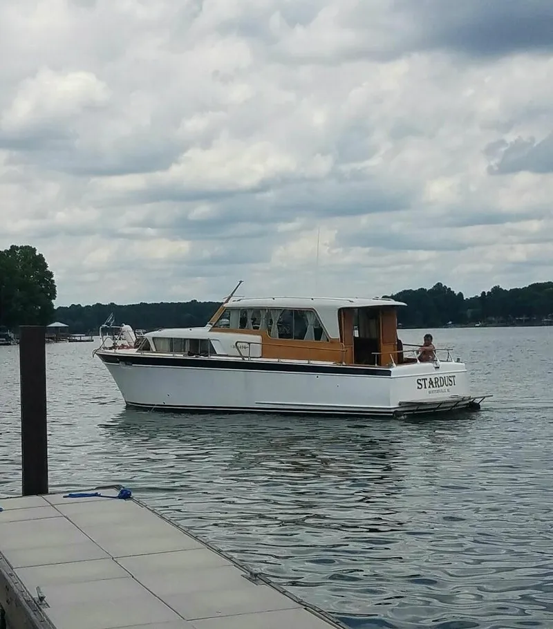 Slide: The Image of 1960 Chris-Craft Roamer boat named Stardust on a lake near a dock. - 2