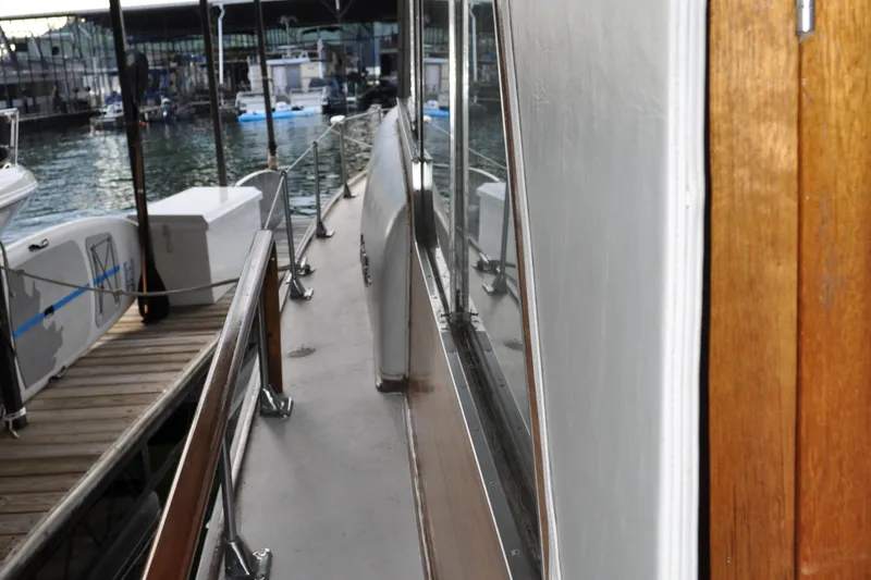 Slide: The Image of 1960 Chris-Craft Roamer yacht docked, showcasing side deck and railing. - 20