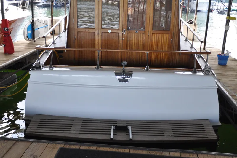 Slide: The Image of 1960 Chris-Craft Roamer boat docked with wooden cabin and white hull. - 21