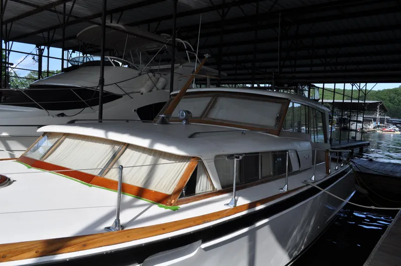 Slide: The Image of 1960 Chris-Craft Roamer boat docked in a covered marina. - 22