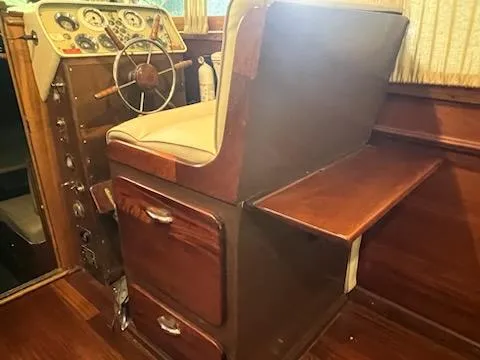 Slide: The Image of 1960 Chris-Craft Roamer boat interior with wooden helm and vintage controls. - 26