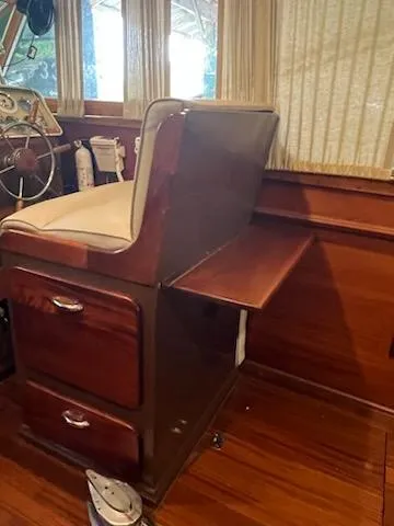 Slide: The Image of 1960 Chris-Craft Roamer interior with wooden cabinetry and captain's chair. - 27
