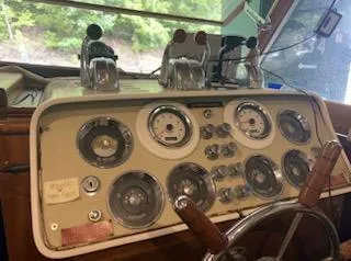Slide: The Image of 1960 Chris-Craft Roamer boat dashboard with gauges and controls. - 32