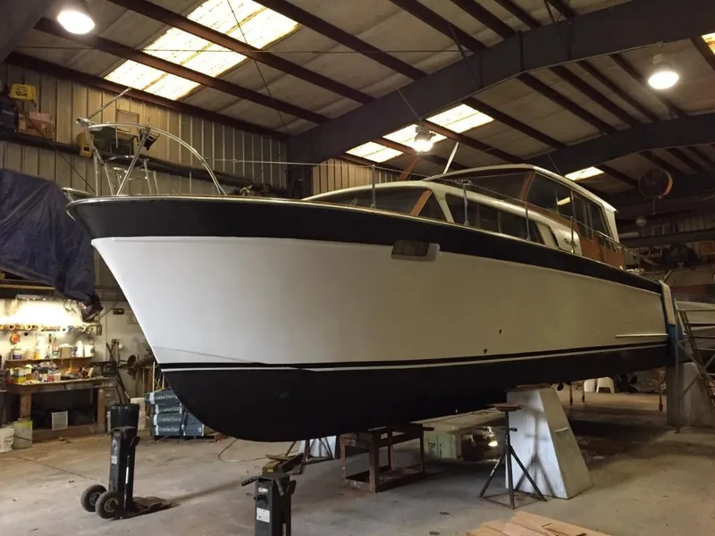 Slide: The Image of 1960 Chris-Craft Roamer boat in a workshop for maintenance. - 4