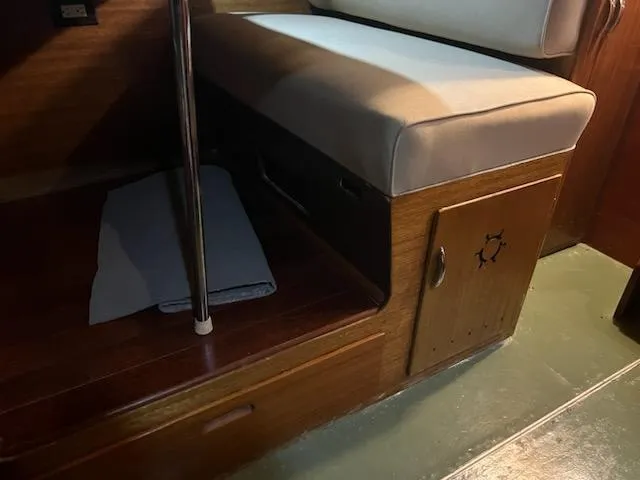 Slide: The Image of Interior of a 1960 Chris-Craft Roamer boat with wooden seating and storage. - 43