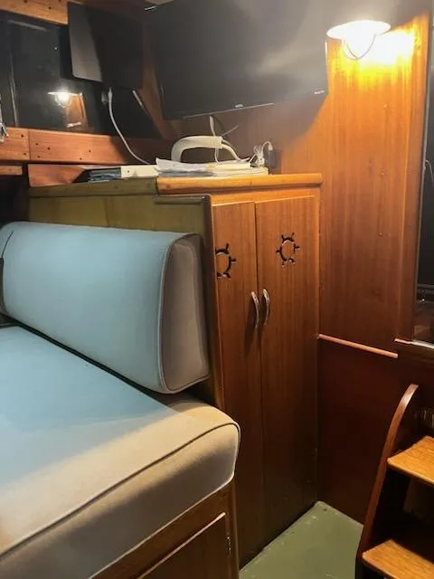 Slide: The Image of 1960 Chris-Craft Roamer interior with wooden cabinetry and cushioned seating. - 44