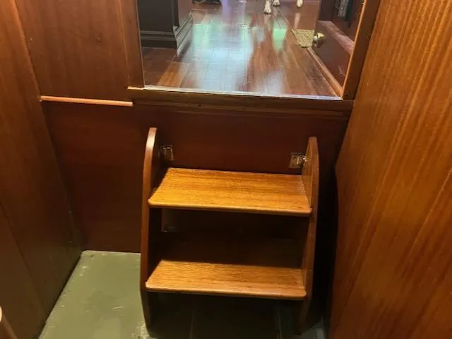 Slide: The Image of Wooden steps inside a 1960 Chris-Craft Roamer boat, leading to a polished interior. - 45