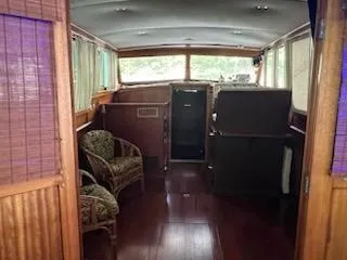 Slide: The Image of Interior of a 1960 Chris-Craft Roamer boat with wooden paneling and seating. - 49