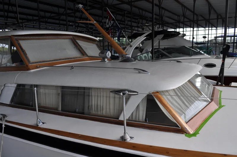 Slide: The Image of 1960 Chris-Craft Roamer boat docked in a covered marina. - 7