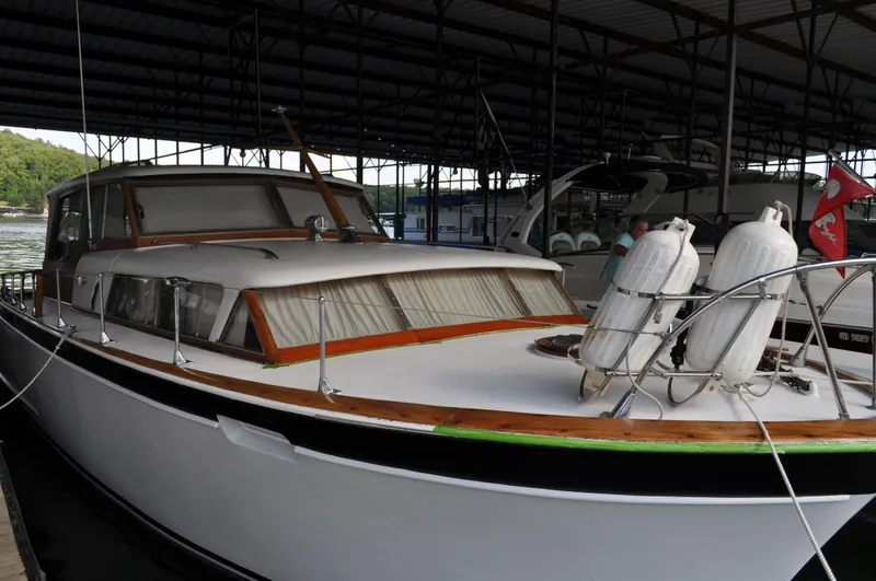 Slide: The Image of 1960 Chris-Craft Roamer yacht docked in a covered marina. - 8