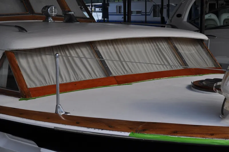 Slide: The Image of 1960 Chris-Craft Roamer boat with wooden trim and covered windows. - 9