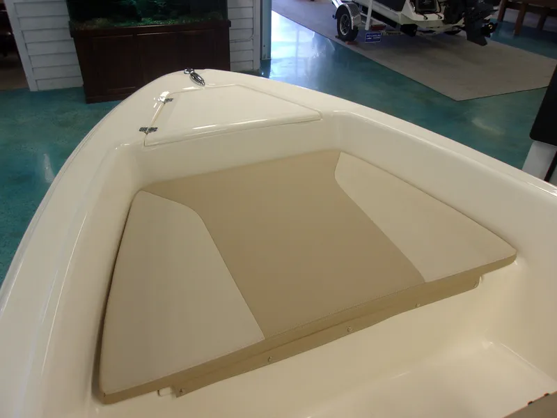 Slide: The Image of 2026 Grady-White Freedom 235 boat in a showroom. - 8