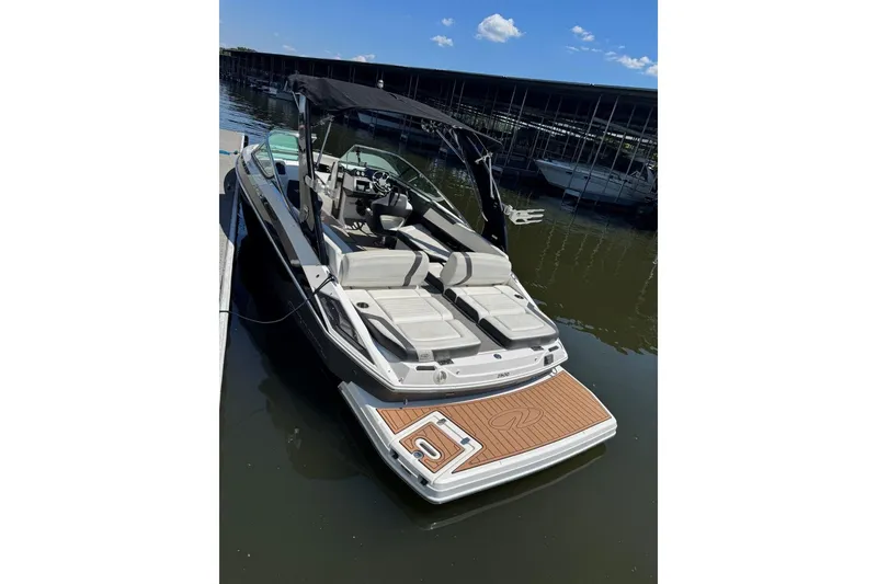 Slide: The Image of 2017 Regal 2500 Bowrider boat docked, featuring spacious seating and sleek design. - 2
