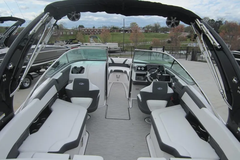 Slide: The Image of 2017 Regal 2500 Bowrider interior with seating and steering wheel, docked outdoors. - 7