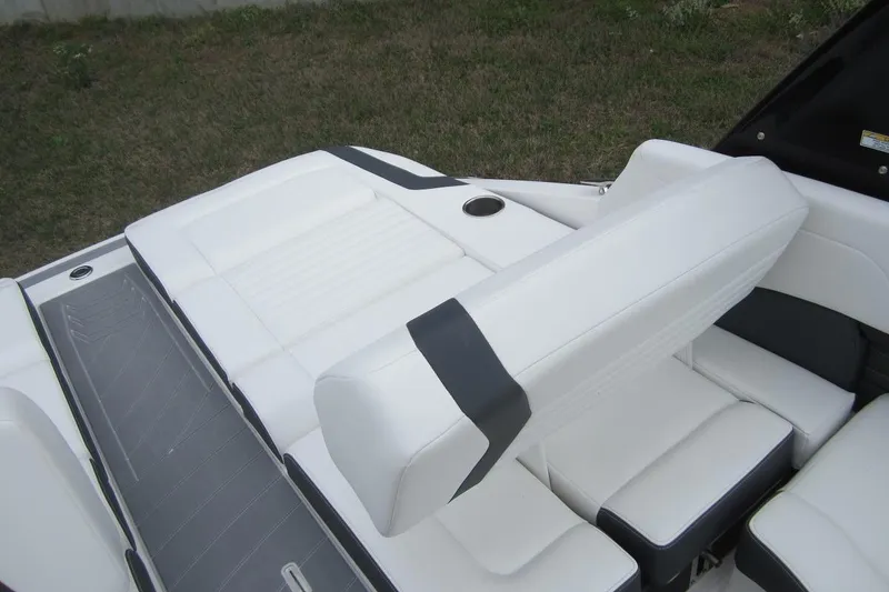 Slide: The Image of 2017 Regal 2500 Bowrider boat interior with white seating and cup holder. - 9