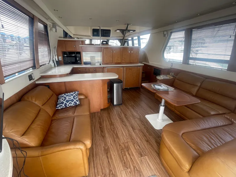 Slide: The Image of Luxurious interior of a 1999 Carver Voyager yacht with leather seating and modern kitchen. - 12