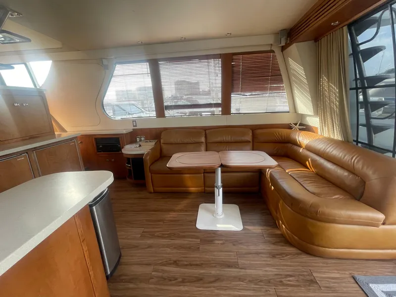 Slide: The Image of Luxurious interior of 1999 Carver Voyager yacht with leather seating and wooden flooring. - 16