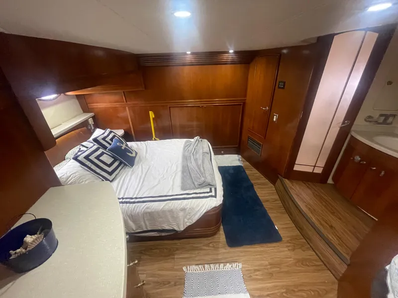 Slide: The Image of Luxurious 1999 Carver Voyager cabin with wood paneling and cozy bedding. - 27