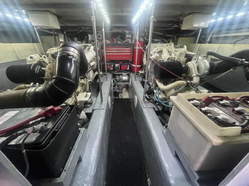 Slide: The Image of Engine room of a 1999 Carver Voyager boat, featuring dual engines and equipment. - 30