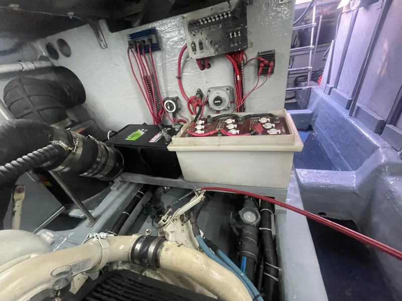 Slide: The Image of Engine room of a 1999 Carver Voyager with visible wiring and battery components. - 32