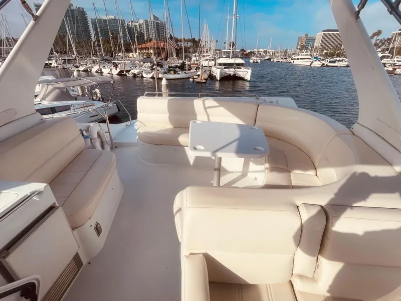 Slide: The Image of Luxurious 1999 Carver Voyager yacht interior with plush seating, docked at a marina. - 8