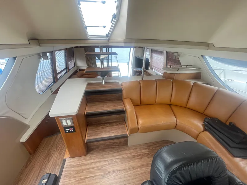 Slide: The Image of Luxurious interior of a 1999 Carver Voyager yacht with leather seating and wood flooring. - 14