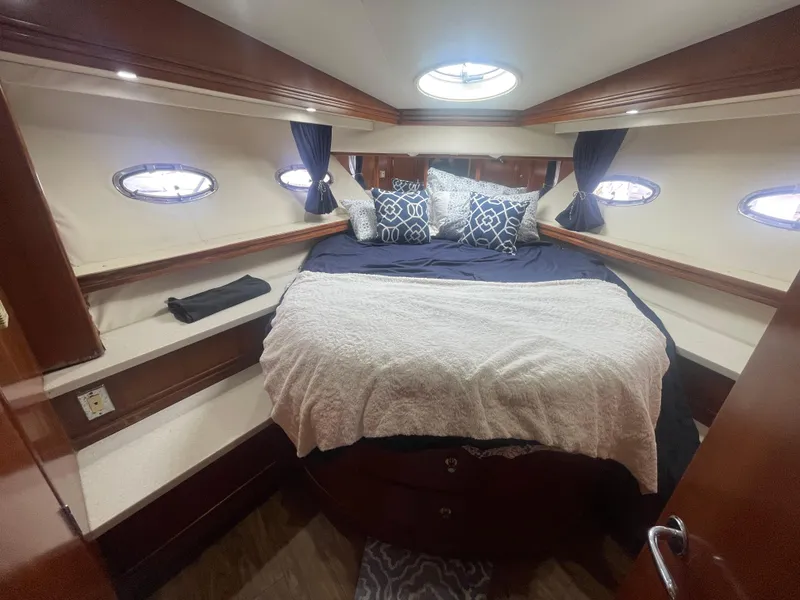 Slide: The Image of Luxurious 1999 Carver Voyager cabin with cozy bed and elegant decor. - 21