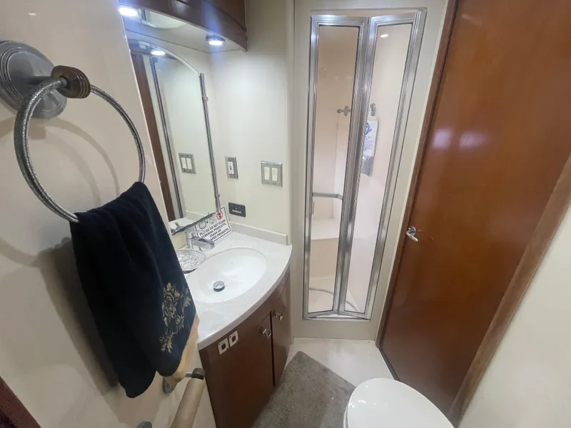 Slide: The Image of Bathroom interior of 1999 Carver Voyager yacht with shower, sink, and towel rack. - 22