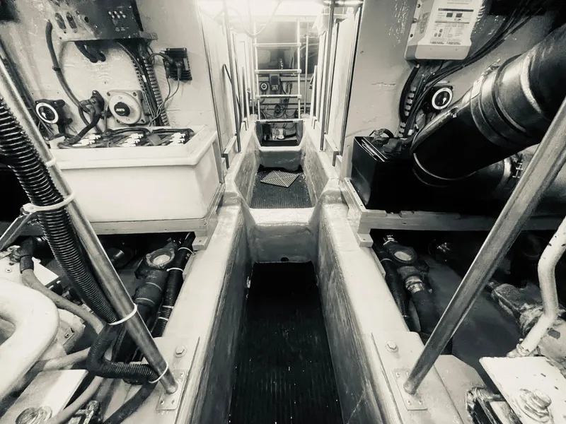 Slide: The Image of Engine room of a 1999 Carver Voyager boat, showcasing mechanical components and equipment. - 29