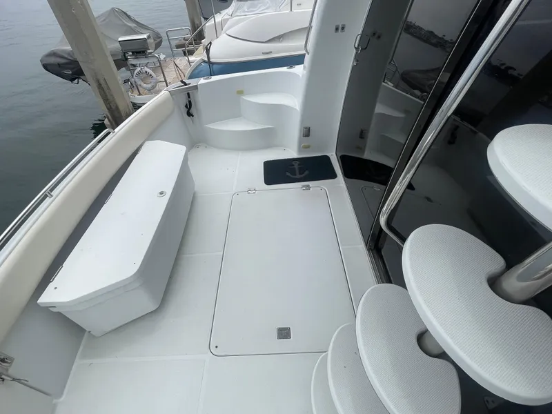 Slide: The Image of 1999 Carver Voyager yacht deck with white seating and spiral staircase. - 5