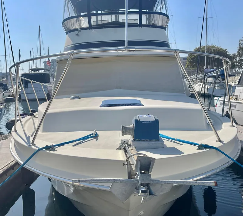 Slide: The Image of 1984 Uniflite Double Cabin Motor Yacht docked in marina, front view. - 1
