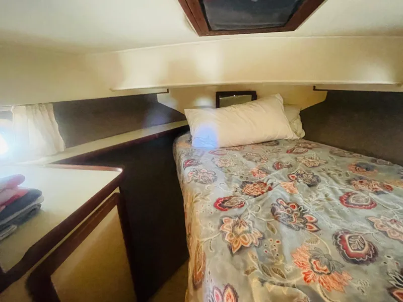 Slide: The Image of Cozy cabin interior of 1984 Uniflite Double Cabin Motor Yacht with floral bedding. - 17