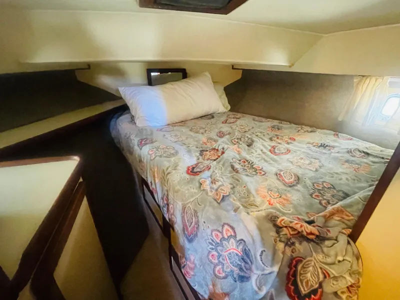 Slide: The Image of 1984 Uniflite Double Cabin Motor Yacht bedroom with floral bedding and cozy interior. - 20