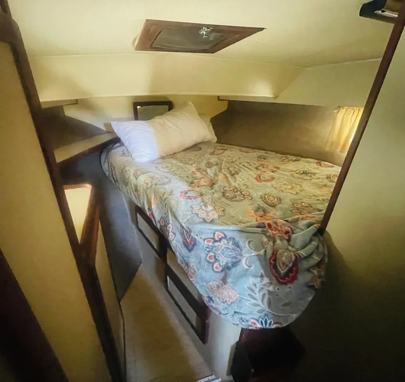 Slide: The Image of Cozy cabin interior of 1984 Uniflite Double Cabin Motor Yacht with floral bedding. - 21