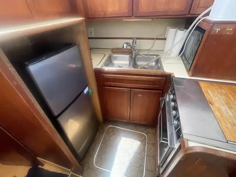 Slide: The Image of 1984 Uniflite Double Cabin Motor Yacht kitchen with sink, stove, and refrigerator. - 23