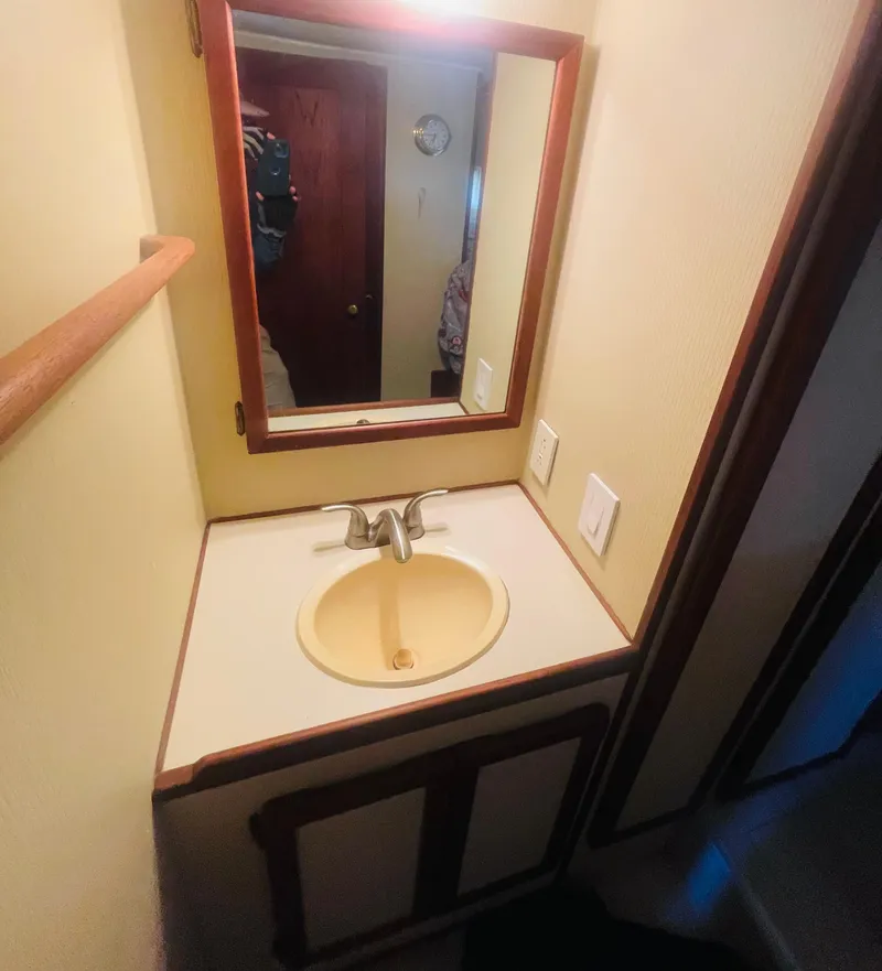 Slide: The Image of 1984 Uniflite Double Cabin Motor Yacht bathroom with sink and mirror. - 38