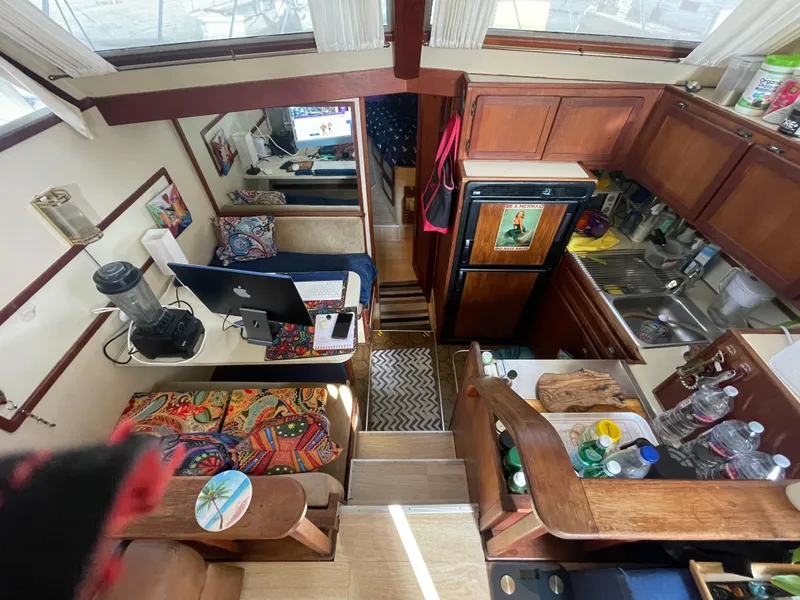 Slide: The Image of 1984 Uniflite Double Cabin Motor Yacht interior with kitchen, seating, and workspace. - 7