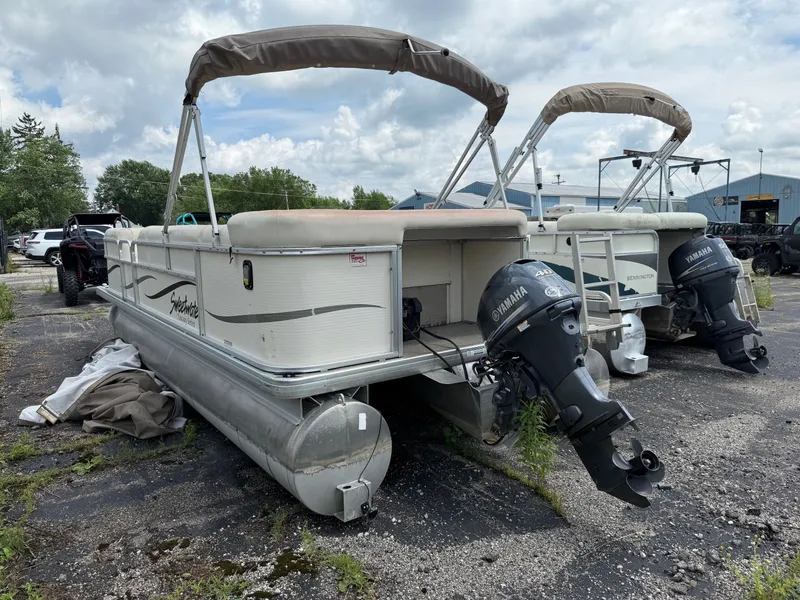 Slide: The Image of 2009 Godfrey Tuscany Series pontoon boat with Yamaha engines on parking lot. - 11
